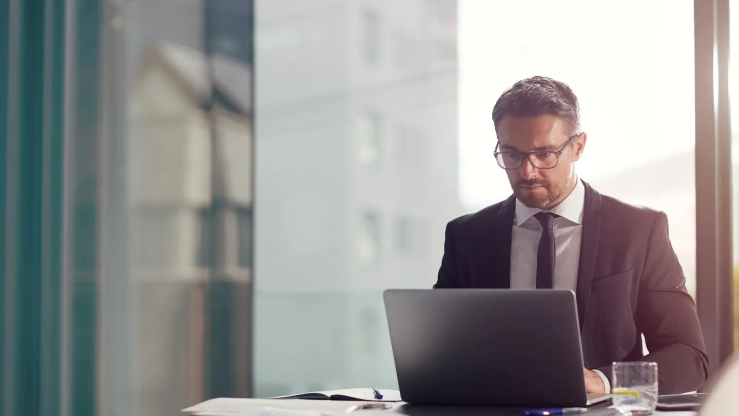 Business owner planning future technology requirements on a laptop