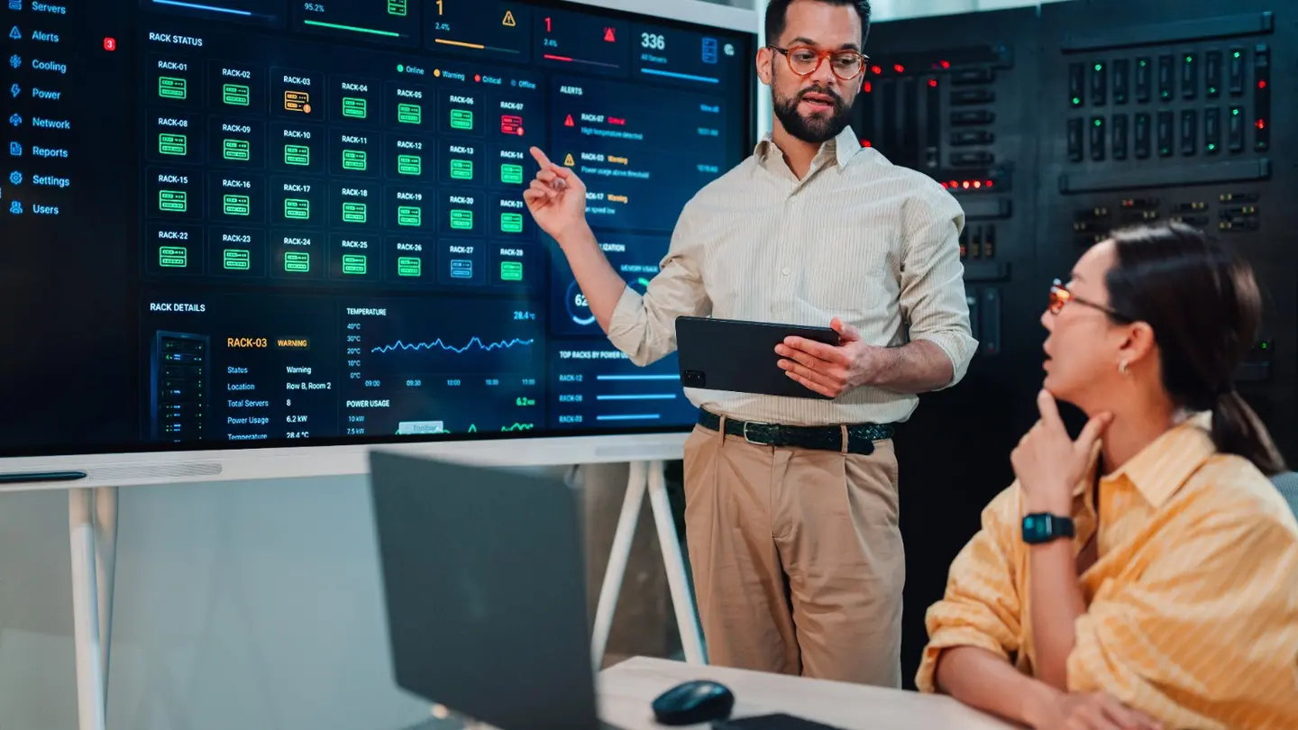 IT professional explaining server monitoring alerts to a colleague