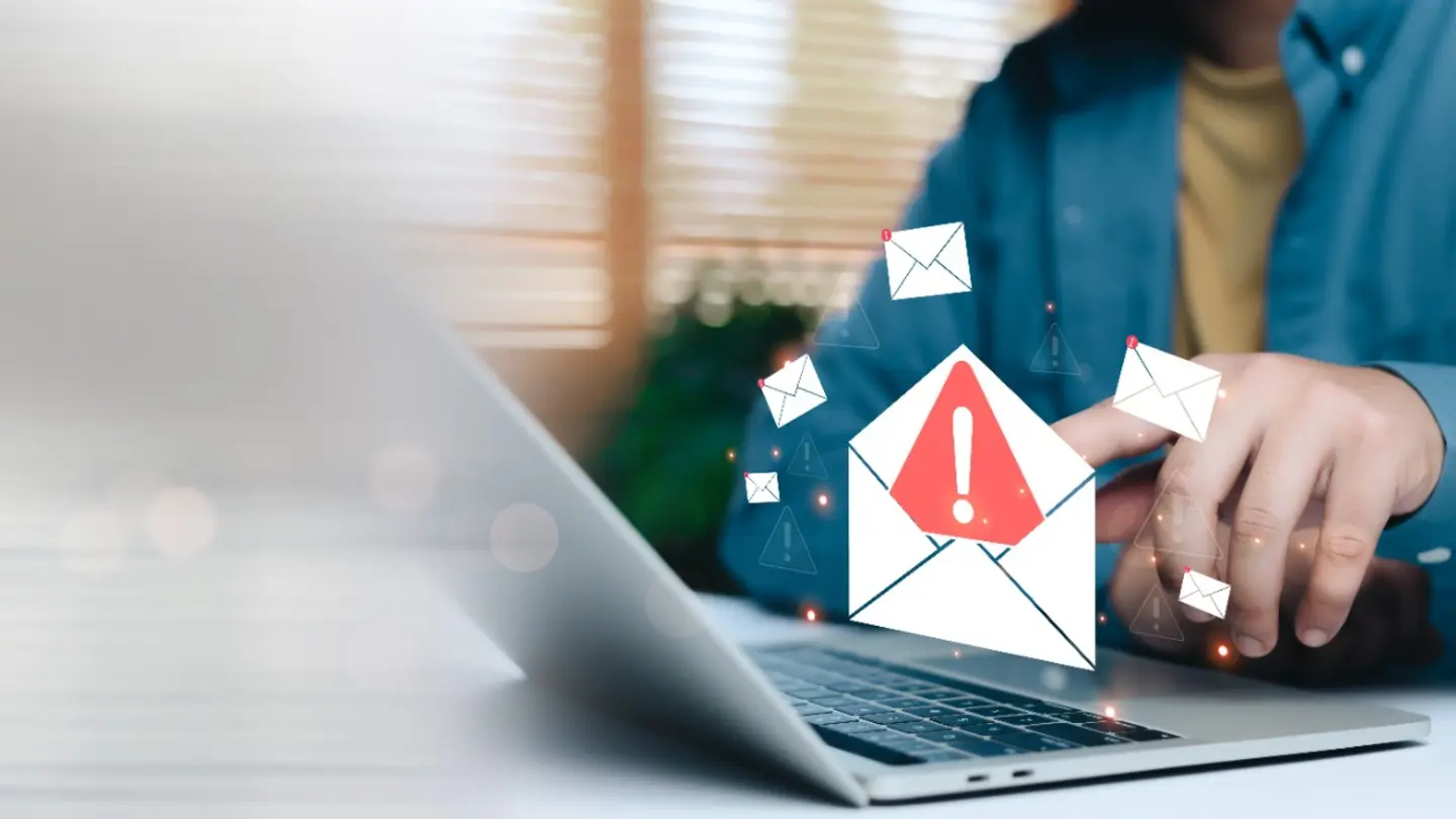 Employee seeing a suspicious phishing email warning on a laptop